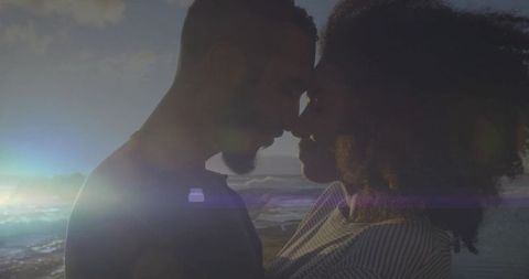 Romantic Couple Embracing on Sandy Shore at Sunset