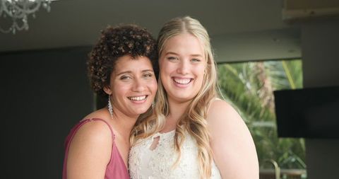 Joyful Bride with Bridesmaid Sharing Moment Before Wedding Ceremony