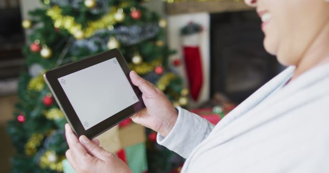 Person Videocalling Friend on Tablet During Christmas Celebration at Home - Download Free Stock Images Pikwizard.com