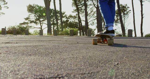 A person enjoys skateboarding on a sunny day, with copy space. Capturing the essence of outdoor leisure, the image evokes a sense of freedom and the joy of skate culture.