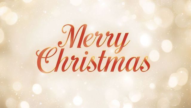 Merry christmas script over golden bokeh glow with subtle sparkles for holiday design