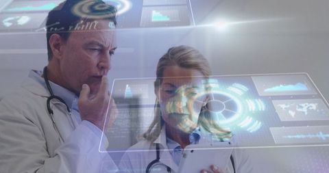 Doctors analyzing data with futuristic technology in medical lab