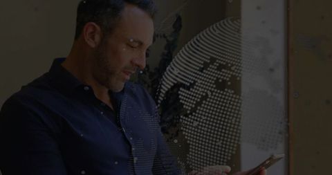 Executive Using Smartphone with Digital Globe Overlay at Office Window for Data Insights
