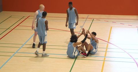 Basketball team warm-up on indoor court: drill and strategy focus