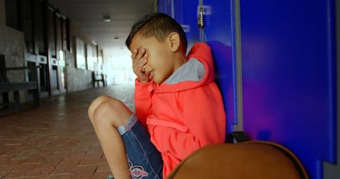 Sad Schoolboy Sitting Alone in Corridor Covering Face - Download Free Stock Images Pikwizard.com