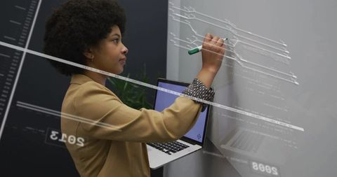 Innovative developer drawing digital designs on transparent board