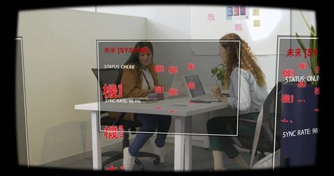Businesswomen discussing at office nook with ar interface overlay, laptops collaboration