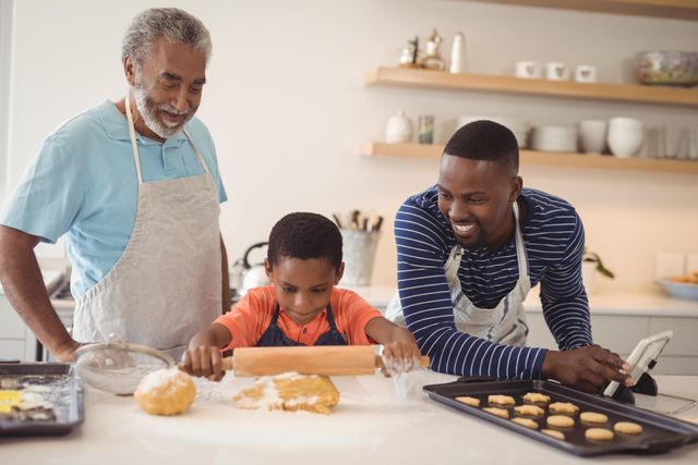 Boy preparing cookie dough with his father and grandfather in kitchen - Download Free Stock Photos Pikwizard.com