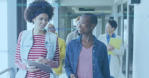 Collaborative Team Discussion in Modern Office Hallway