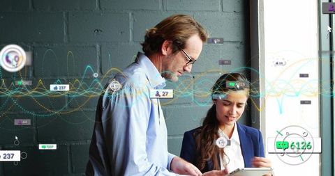 Professionals collaborating on tablet with dynamic data visualization and analytics