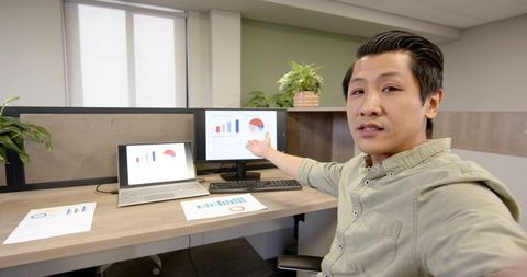 Business Presentation with Laptop and Graphs in Office Setting