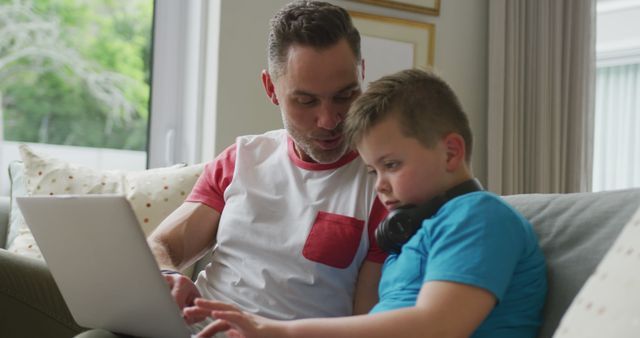 Father Teaching Son Using Laptop in Comfortable Living Room - Download Free Stock Images Pikwizard.com