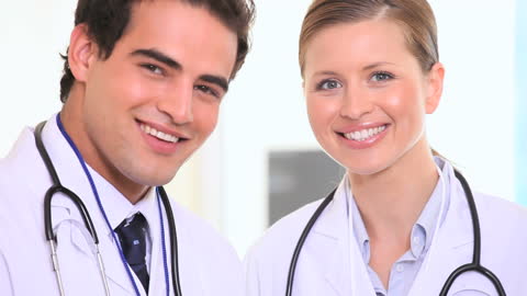 Smiling Medical Team: Two Doctors in White Coats