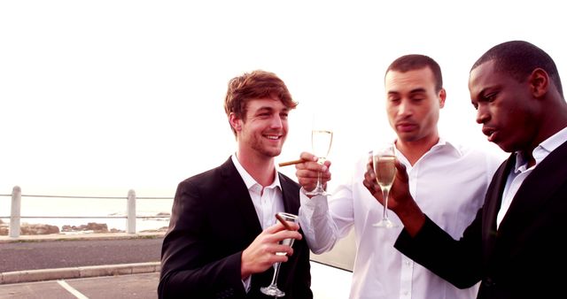 Group of Men Toasting with Champagne in Outdoor Celebration - Download Free Stock Images Pikwizard.com