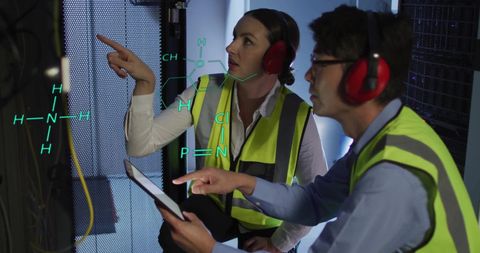 It technicians analyzing scientific data in server room