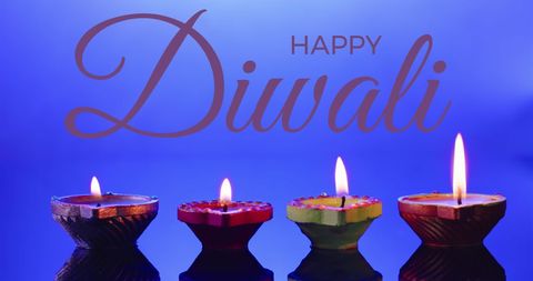 Happy diwali greeting with lit colorful diyas on purple background