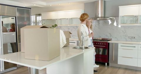 Couple Exploring New Kitchen During Moving Day