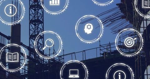 Silhouetting tower crane and scaffolding with overlaying digital industry icons