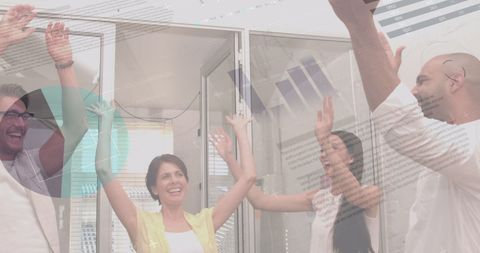 Team Celebration in Modern Office with Success Charts Overlay