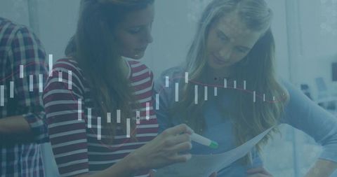 Two women analyzing business statistics at work