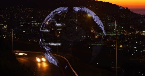 Glowing digital globe hovering over nighttime highway highlighting japan china philippines