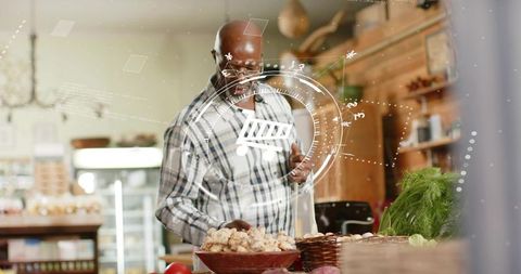 Mature shopkeeper checking fresh mushrooms at rustic grocery with digital HUD overlay