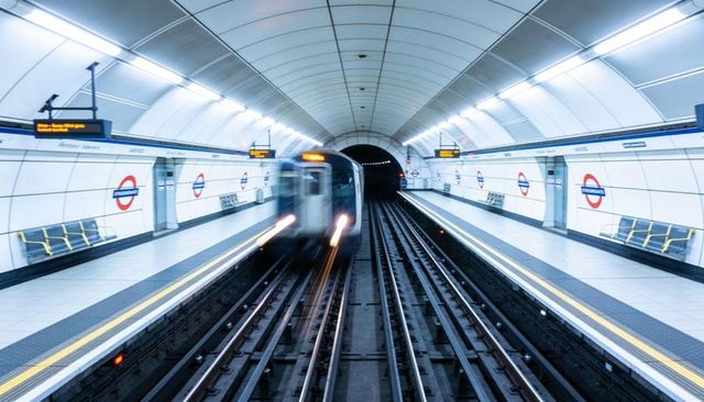 High-speed subway train approaching underground platform with motion blur and leading lines