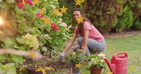 Smiling Woman Gardening with Flowers in Green Backyard