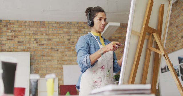 Female Artist Painting on Canvas While Listening to Music - Download Free Stock Images Pikwizard.com
