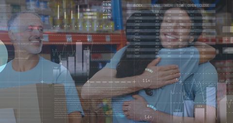 Joyful workers embrace amidst logistics and data visualizations