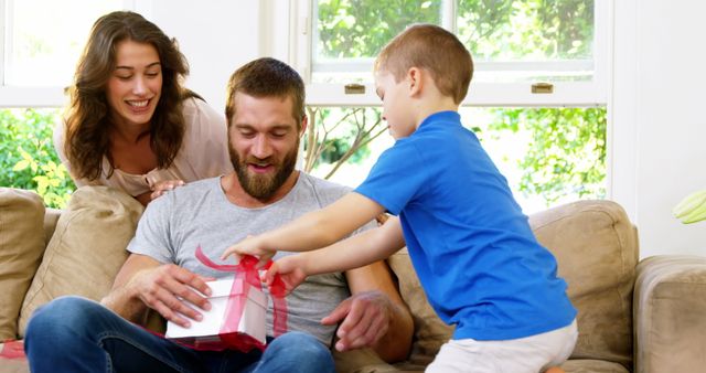 Family Celebrates Father's Day with Gift at Home - Download Free Stock Images Pikwizard.com