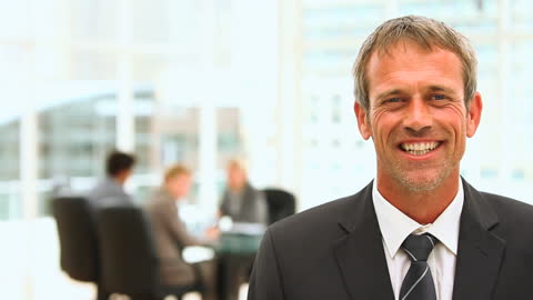 Confident Businessman Smiling in Corporate Office Environment