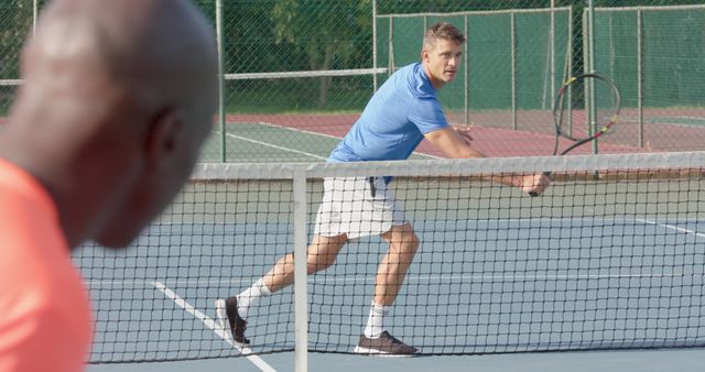 Men playing competitive tennis match on outdoor court - Download Free Stock Images Pikwizard.com