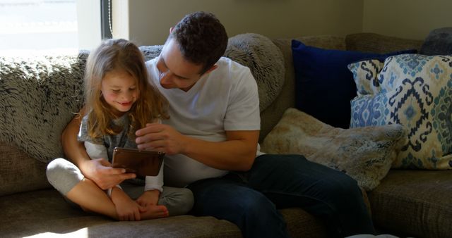 Father Spending Quality Time with Daughter at Home Reading Tablet - Download Free Stock Images Pikwizard.com