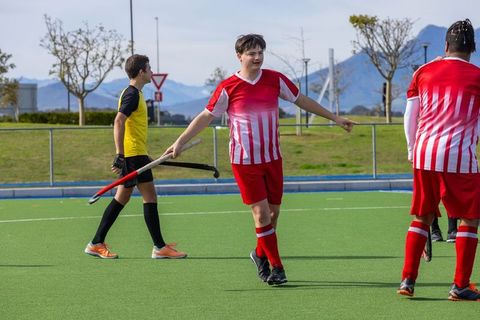 Diverse Field Hockey Players in Action on Synthetic Turf