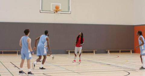 Basketball Team Practicing Driven Shooting in Indoor Court
