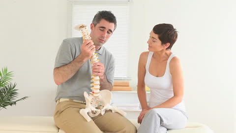 Chiropractor Discussing Spine Structure with Patient