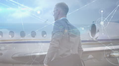 Businessman at Airport with Digital Network Overlay
