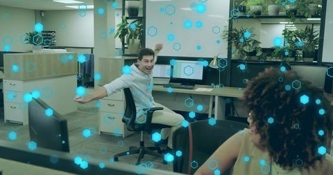 Jubilant Male Worker Enthusiastically Interacting in Modern Office