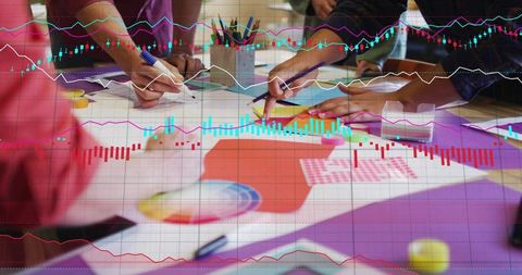 Design team sketching mockups with stock market overlays and collaborative brainstorming
