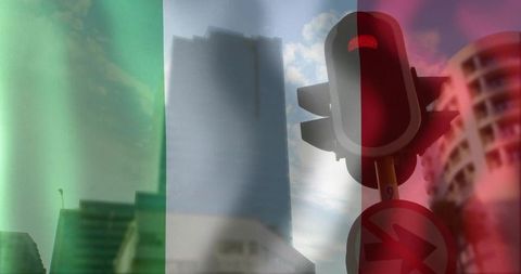 Red traffic light glowing by highrise with tricolor flag overlay for dramatic downtown cityscape