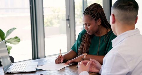 Professionals discussing strategy at workplace meeting