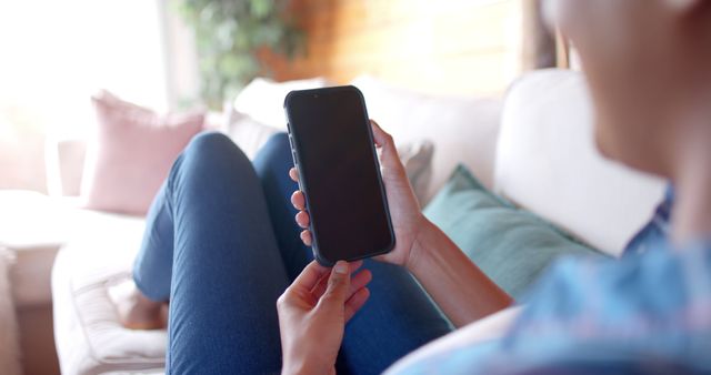 Person Relaxing on Couch Using Mobile Phone at Home - Download Free Stock Images Pikwizard.com