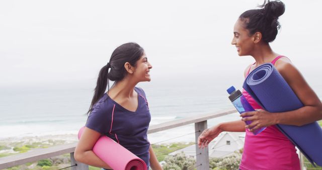 Two Happy Women with Yoga Mats Chatting Outdoors Near Beach - Download Free Stock Images Pikwizard.com