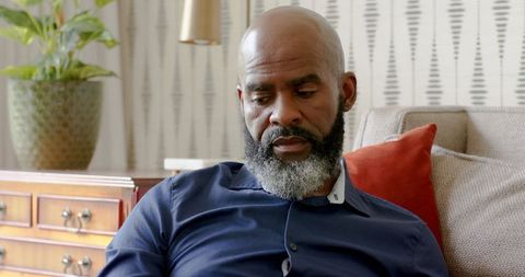 Man Relaxing at Home Using Tablet in Cozy Living Room