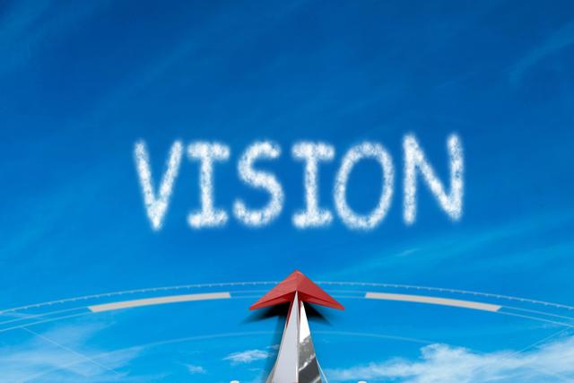 Compass pointing towards the word 'VISION' written in the sky. Ideal for concepts related to direction, guidance, goal setting, future aspirations, motivation, and success. Suitable for business presentations, motivational posters, and strategic planning materials.