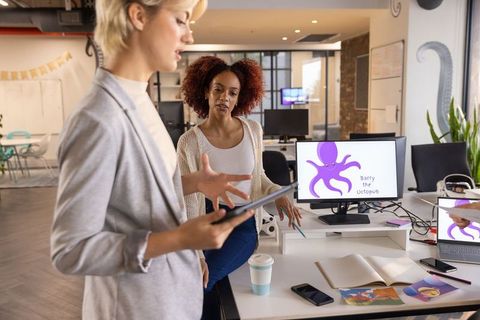 Creative teamwork in modern office with digital cartoons