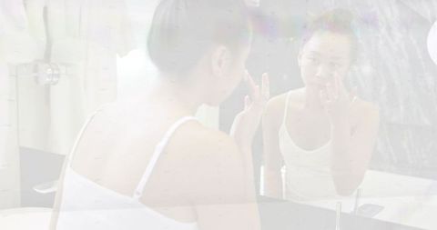 Applying eye cream at vanity mirror, morning skincare routine, calm self-care moment