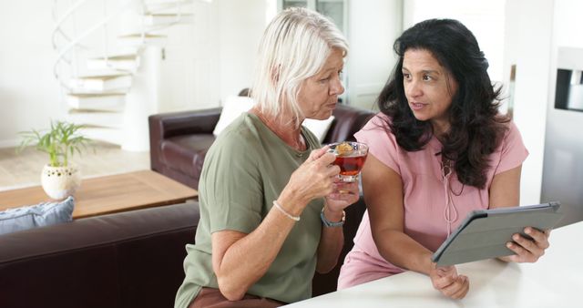 Senior Women Engaging in Conversation and Sharing Digital Tablet - Download Free Stock Images Pikwizard.com