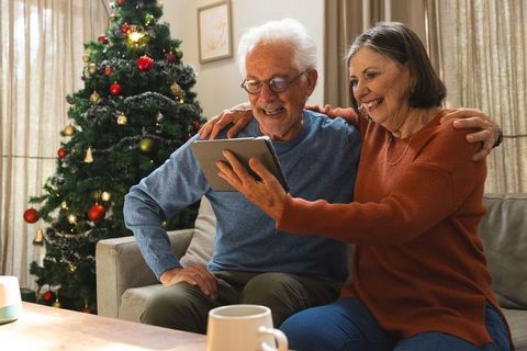 Senior couple browsing tablet together during christmas